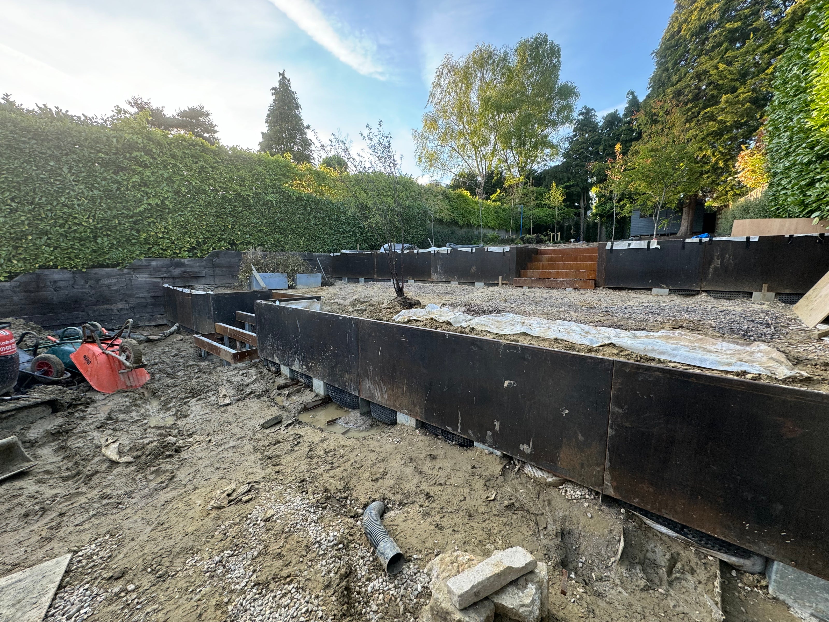 Corten steel retaining wall and steps under construction