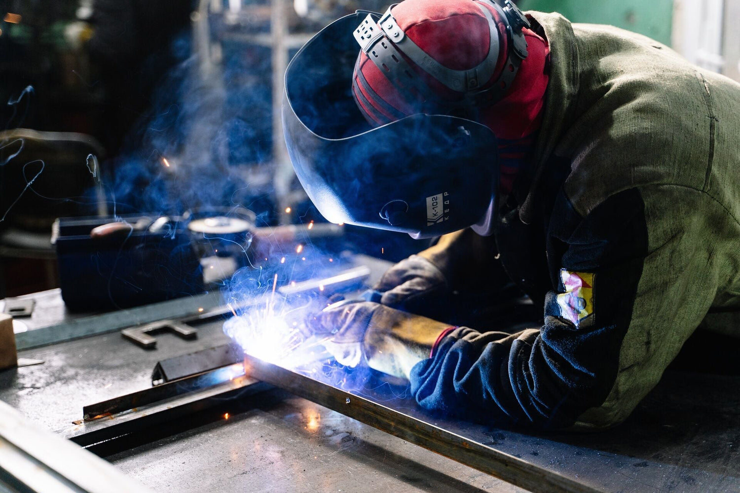 Sheet metal worker welding in a factory in Southampton, UK